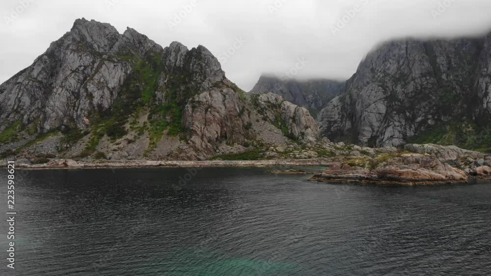 Fjord landscape. Lofoten islands in North Norway near Henningsvaer village. Hazy rainy day, overcast weather Fjord landscape. Lofoten islands in North Norway near Henningsvaer village. Hazy rainy day, overcast weather
