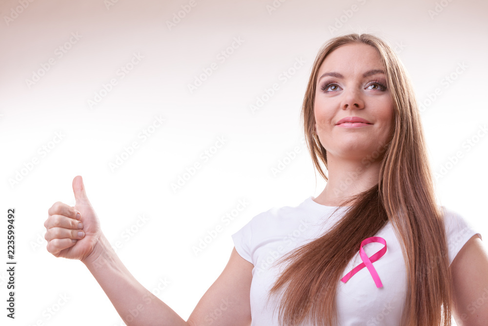 woman pink cancer ribbon on chest making thumb up woman pink cancer ribbon on chest making thumb up
