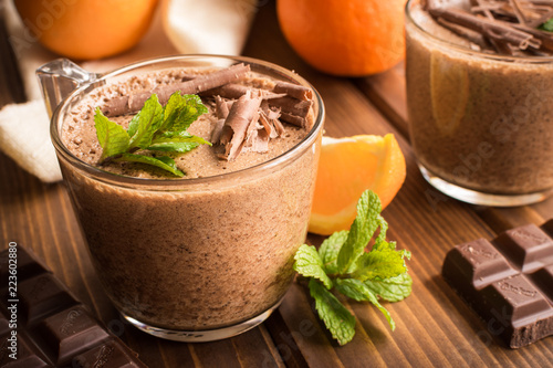 chocolate mousse dessert with orange on rustic wooden background.