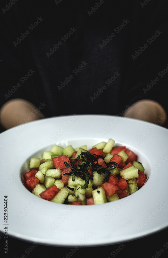Midsection of woman holding fruit salad served in plate Midsection of woman holding fruit salad served in plate
