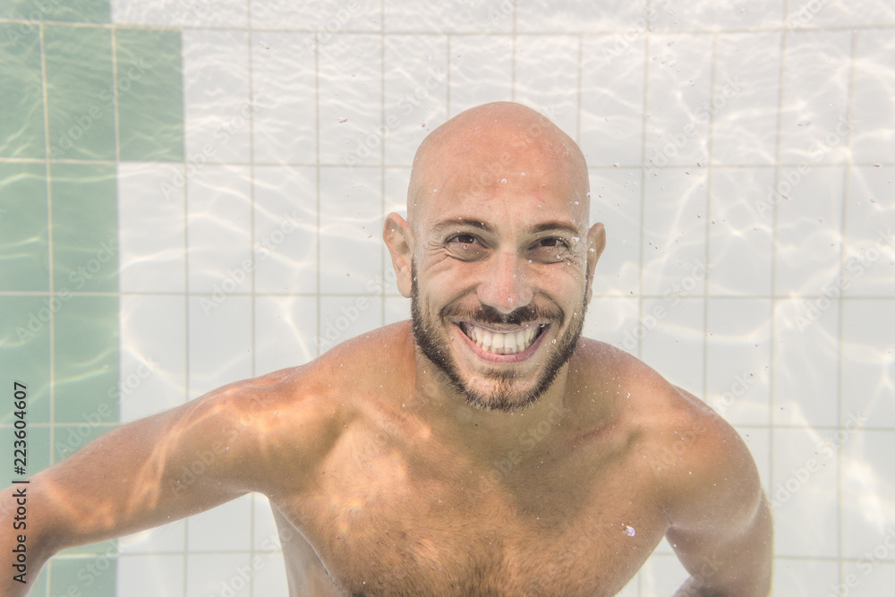 Portrait of cheerful bald swimmer in swimming pool Portrait of cheerful bald swimmer in swimming pool