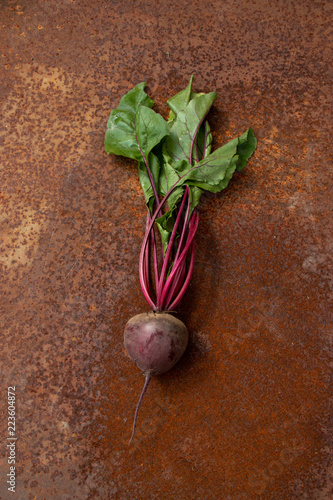 Raw beetroots from new harvest on rusty melallic surface background photo