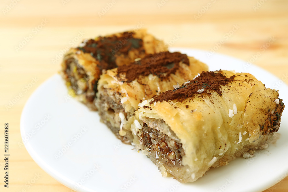 Closed up a place of three pieces of delicious Baklava sweets served on wooden table Closed up a place of three pieces of delicious Baklava sweets served on wooden table