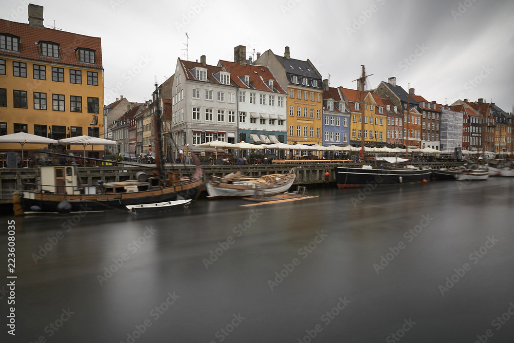 Boats moored in canal against buildings at city Boats moored in canal against buildings at city
