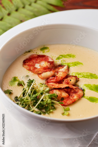 Creamy cheese soup with grilled shrimps