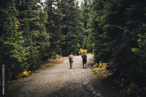 A couple walking on a mountain path in Colorado during fall. 