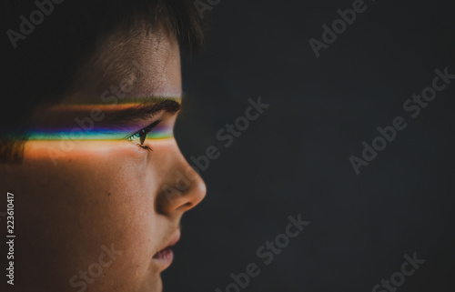 Close up of thoughtful boy with spectrum on eyes