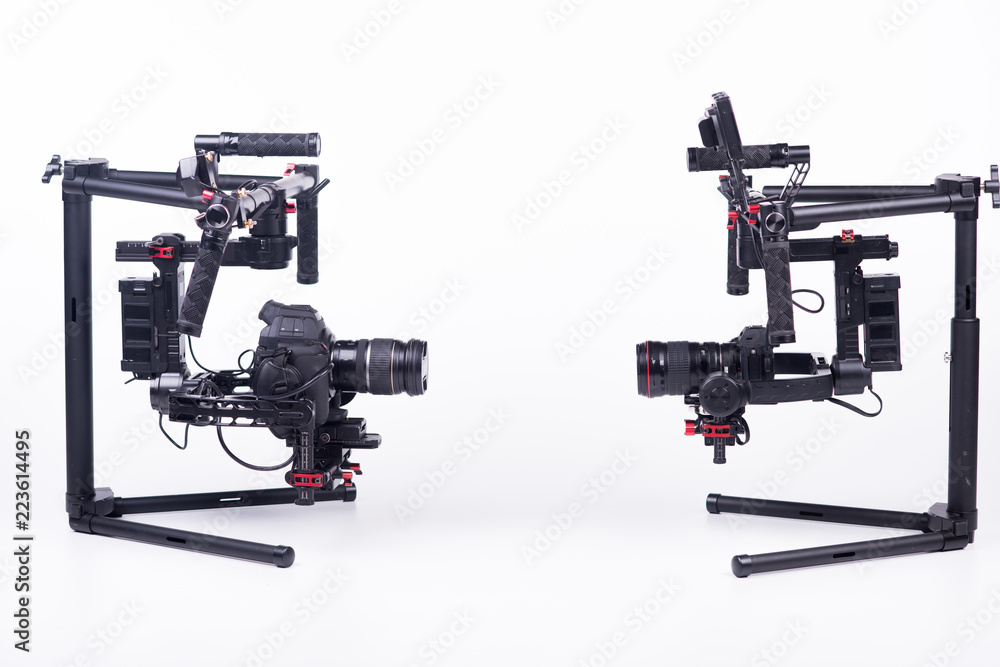 Systems stabilization video camera and lens on steady equipment support such as gimbal steady or stabilized. White background. Systems stabilization video camera and lens on steady equipment support such as gimbal steady or stabilized. White background.