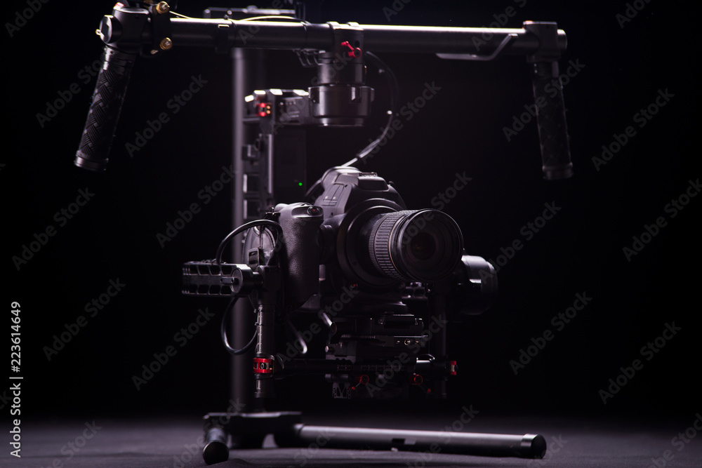 Fototapeta premium Systems stabilization video camera and lens on steady equipment support such as gimbal steady or stabilized. Black background