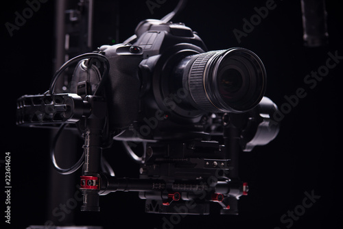 Systems stabilization video camera and lens on steady equipment support such as gimbal steady or stabilized. Black background