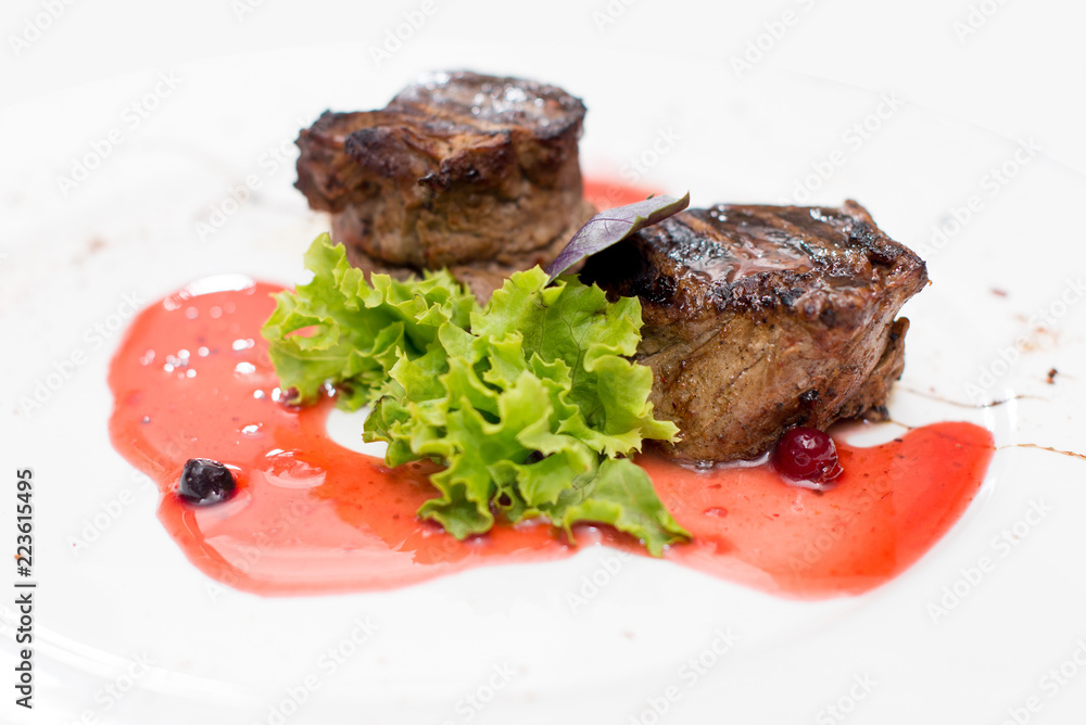 grilled beef steaks with spices isolated on white background grilled beef steaks with spices isolated on white background