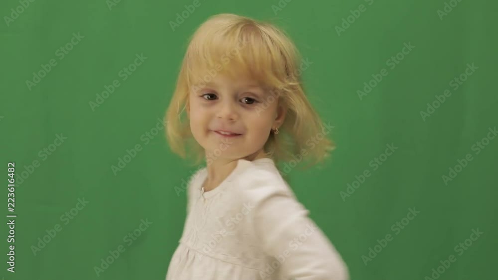 Happy three years old girl. Cute blonde child. Brown eyes. Green screen Happy three years old girl. Cute blonde child. Brown eyes. Green screen