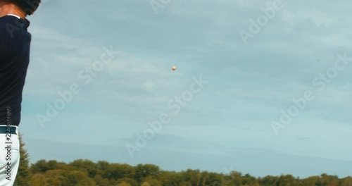 CU Portrait of batter baseball player hits a ball against cloudy sky. 4K UHD 60 FPS SLO MO RAW photo