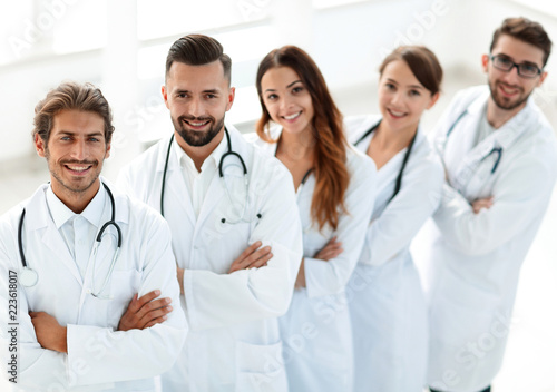 medical team standing with arms crossed on a white background
