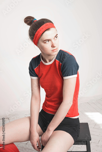 Woman in uniform on white background. Red t-shirt, headband and socks. Retro style of 80's, 90's.