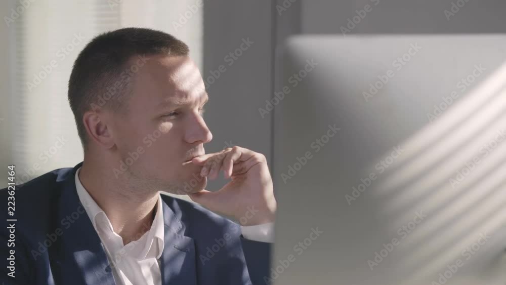 Young handsome man sitting in office and thinking Young handsome man sitting in office and thinking