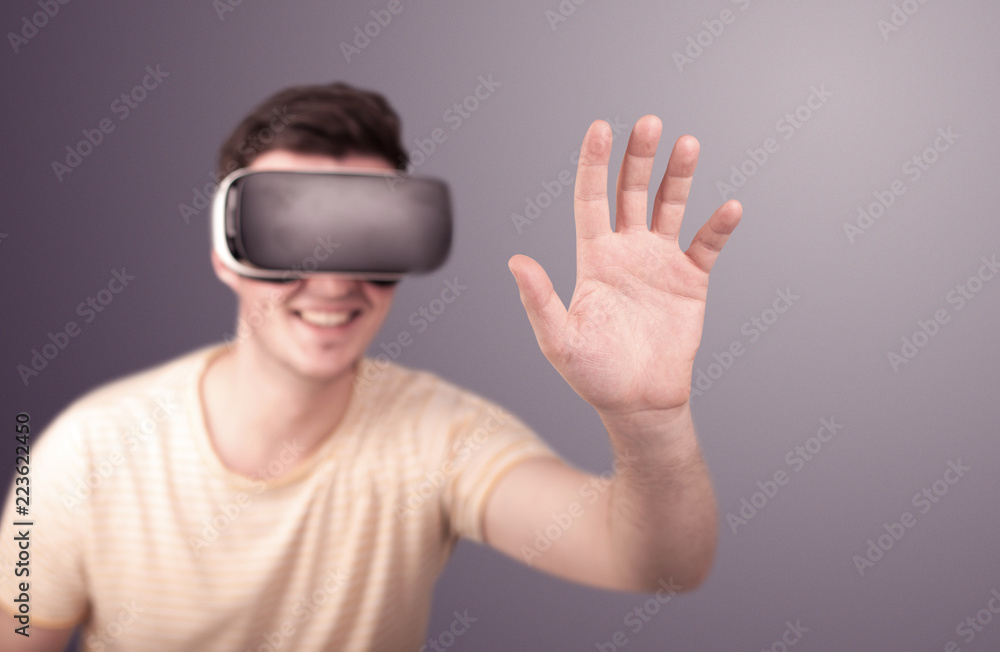 Young impressed man wearing virtual reality goggles Young impressed man wearing virtual reality goggles