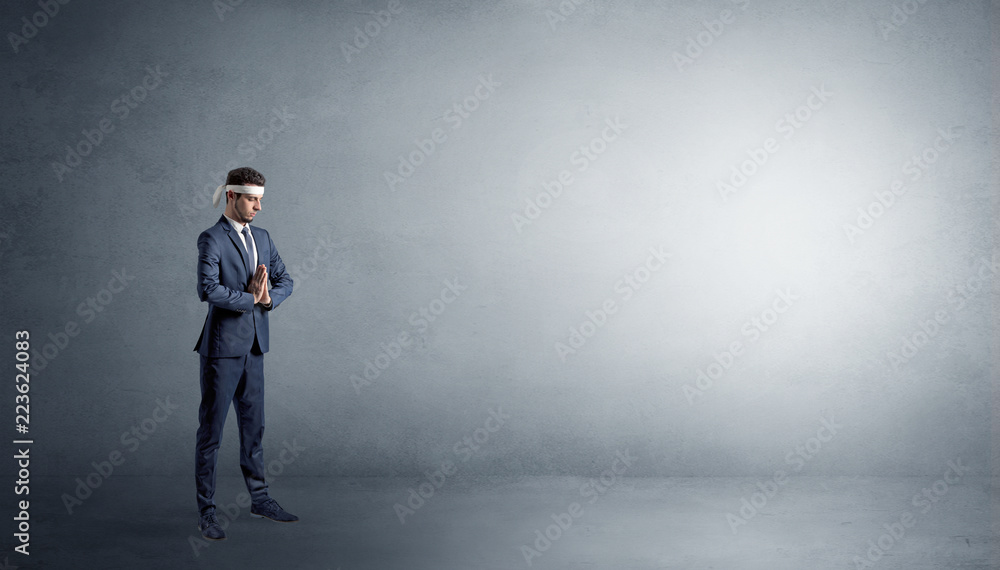 Small karate man fighting in an empty grey copy space Small karate man fighting in an empty grey copy space