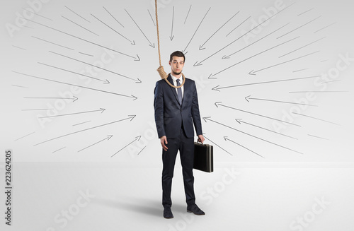 Hopeless young businessman trying to suicide with question signs concept 