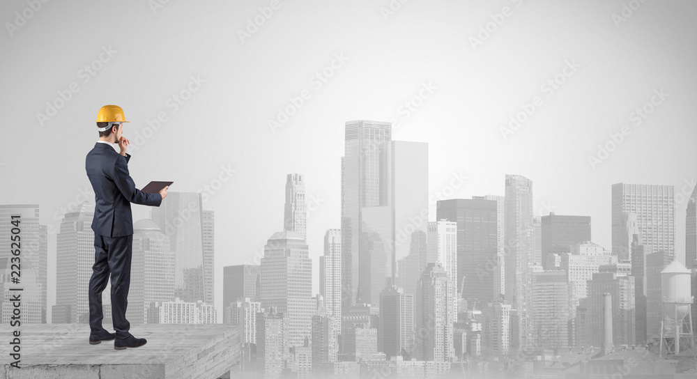 Architect standing on maze and looking at a future plan
