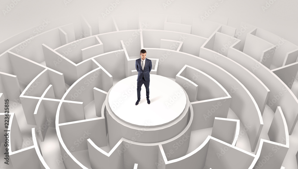 Businessman standing on the top a maze and looking through
Businessman standing on the top a maze and looking through