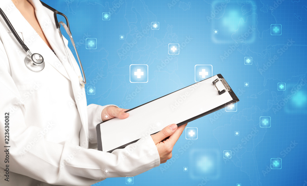 Female doctor holding notepad with blue background and crosses Female doctor holding notepad with blue background and crosses