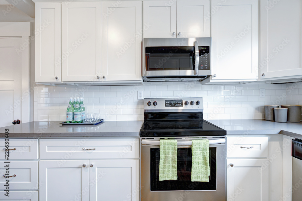 White and gray kitchen room with modern appliances. White and gray kitchen room with modern appliances.