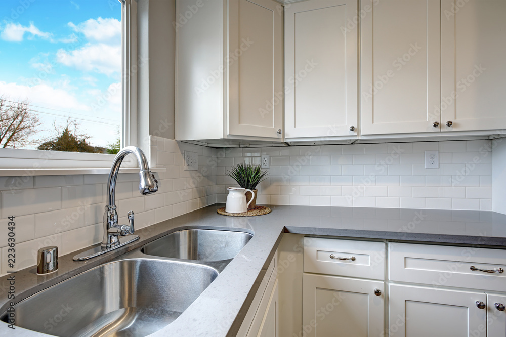 White and gray kitchen room with modern appliances. White and gray kitchen room with modern appliances.