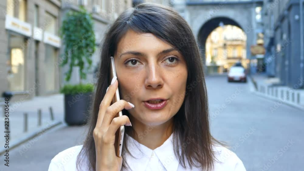 4K. Business woman talk Smartphone mobile at city street. Face close up 4K. Business woman talk Smartphone mobile at city street. Face close up
