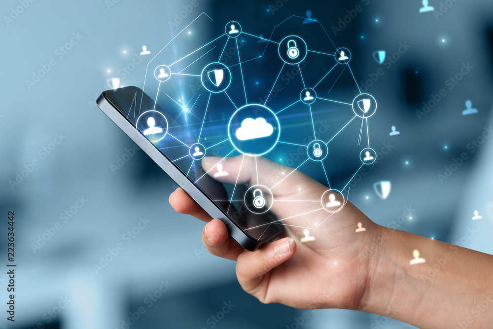 Hand using phone with centralized cloud computing system and network security concept