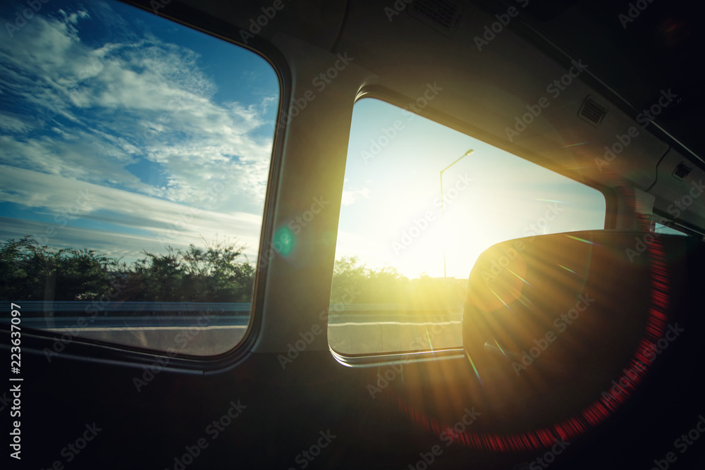 Fototapeta premium Sunset landscape looking out the car window