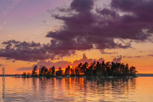 Orange Skies Behind Island and Lake photo