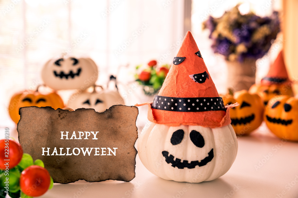 White and yellow ghost pumpkins with witch hat and Happy halloween text on borad. halloween concept.