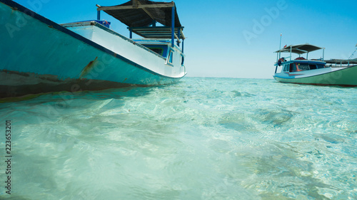 closeup boat with green sea and traditional boat shoot from behind or under sea