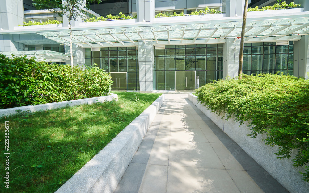 Pathway in the garden with modern office background . Pathway in the garden with modern office background .