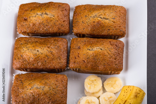 Banana Loaves with banana slices on a white tray showing top view