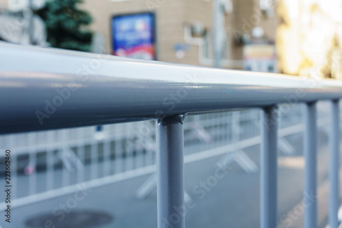 Portable metal grilles of light gray color for the obstruction of the territory and organization of the queue for the event