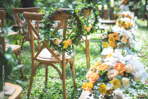 Chair decorated with flowers in forest Wedding ceremony.