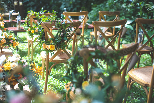 Chair decorated with flowers in forest Wedding ceremony.