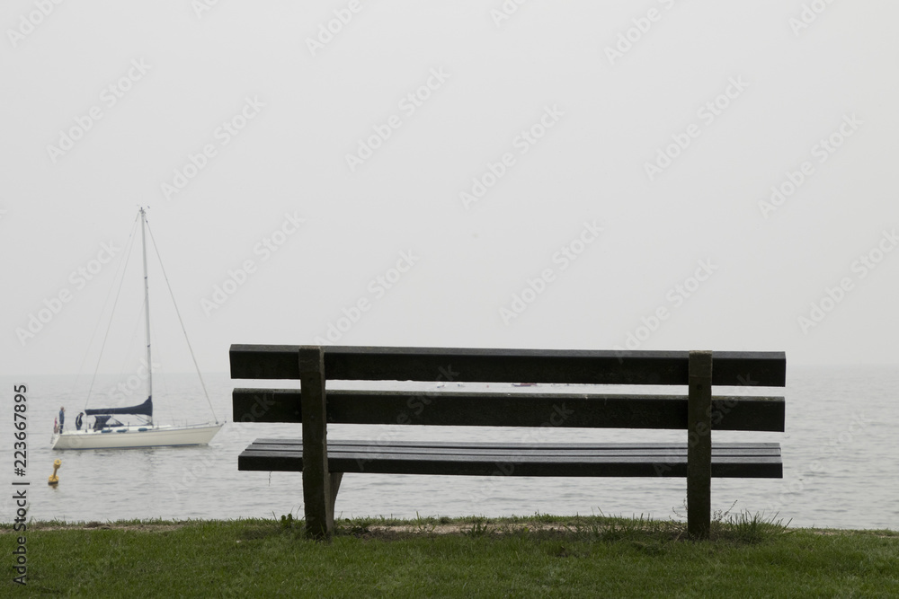 A rustic bench is looking out over the IJsselmeer