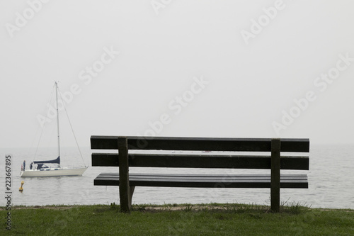 Obraz na płótnie A rustic bench is looking out over the IJsselmeer w salonie