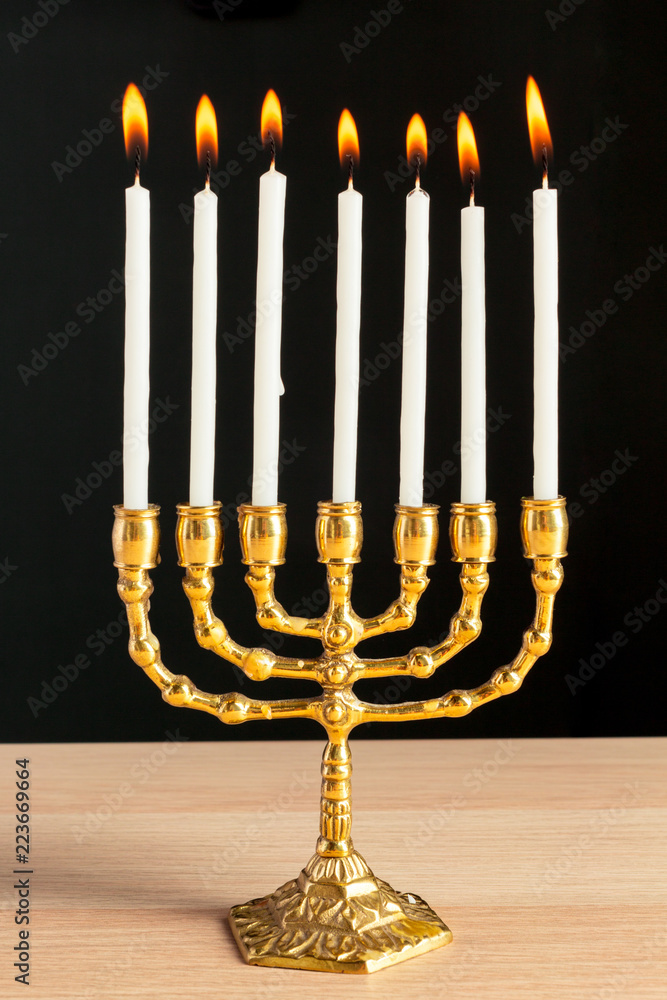 Bronze Hanukkah menorah with burning candles Bronze Hanukkah menorah with burning candles