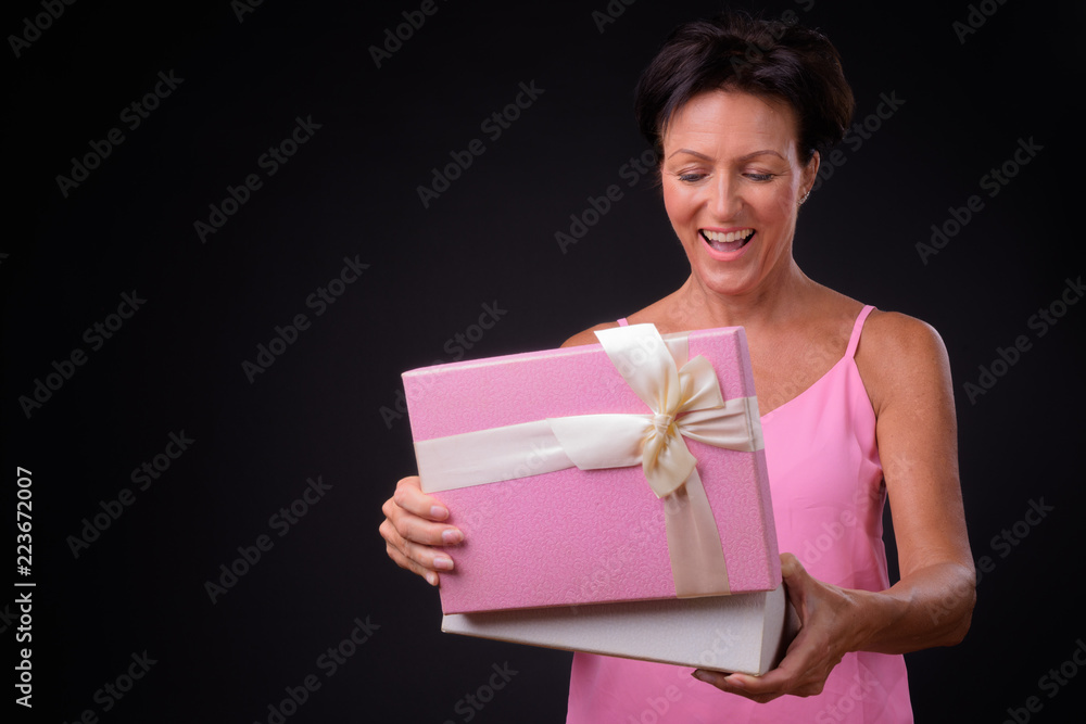 Mature beautiful woman with short hair against black background Mature beautiful woman with short hair against black background