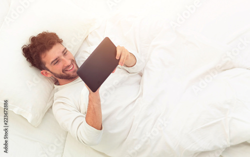 background image . man reading on digital tablet.