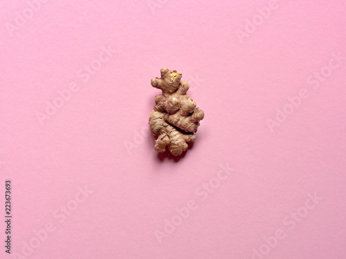 Isolated ginger root over a pink background in studio.