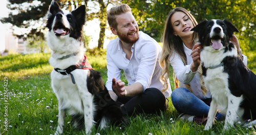 Romantic couple in love walking dogs and bonding