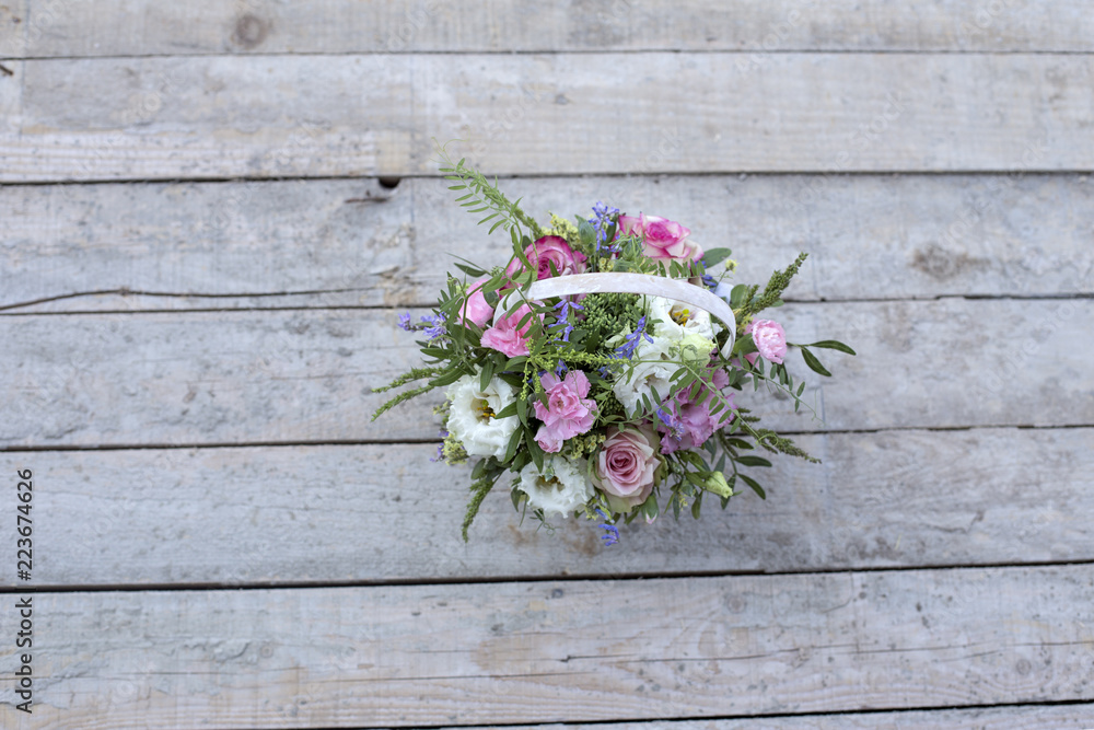 Delicate bouquet of flowers in a white basket Delicate bouquet of flowers in a white basket