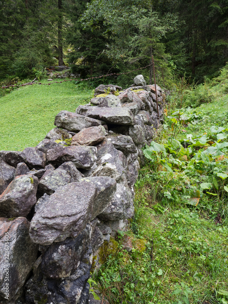 Stone fence on a pasture Stone fence on a pasture