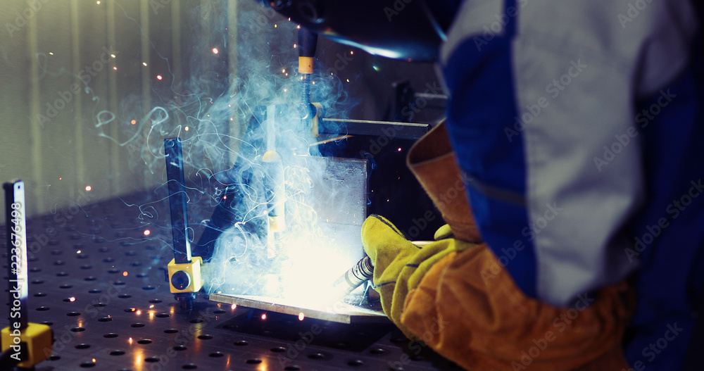 Metal worker welding in metal industry factory Metal worker welding in metal industry factory