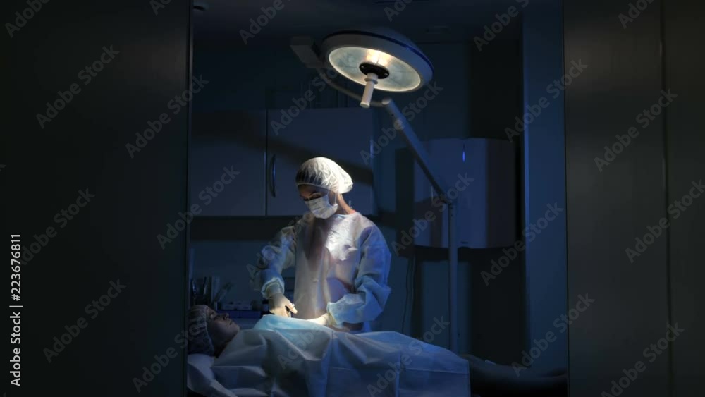 The surgeon is performing surgery for the patient The surgeon is performing surgery for the patient